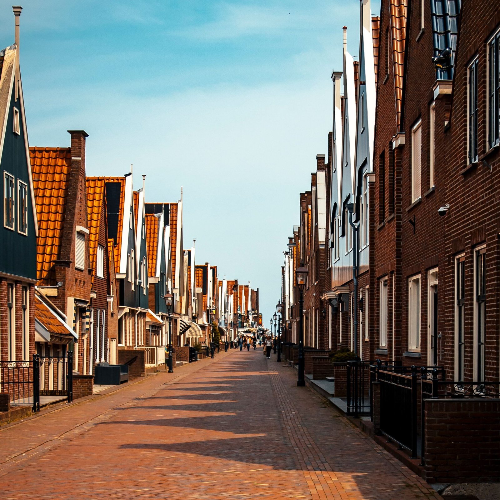 A vibrant street lined with traditional Dutch houses in Volendam, Netherlands, showcasing unique architecture.